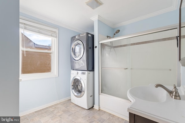 interior space featuring stacked washer and dryer, baseboards, visible vents, ornamental molding, and vanity