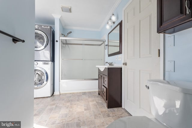 laundry room with laundry area, stacked washing maching and dryer, ornamental molding, and a sink