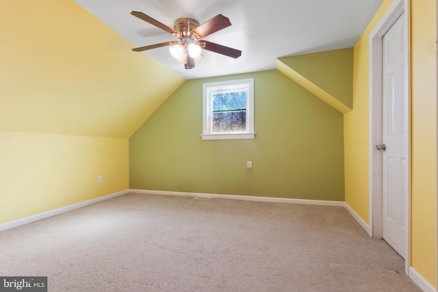 bonus room with ceiling fan, lofted ceiling, light carpet, visible vents, and baseboards