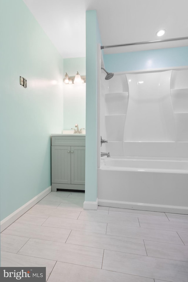 full bathroom featuring vanity, baseboards, and shower / bathtub combination