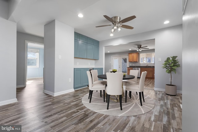 dining space with recessed lighting, dark wood finished floors, and baseboards