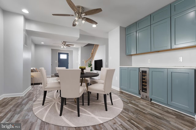 dining room featuring beverage cooler, baseboards, dark wood finished floors, and recessed lighting