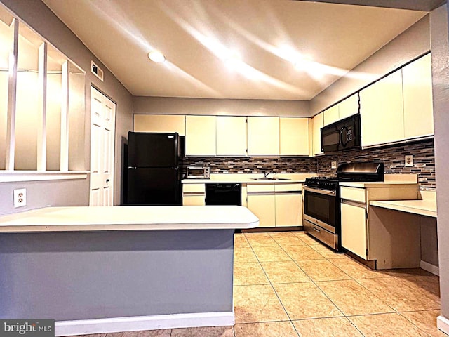 kitchen featuring light countertops, backsplash, black appliances, and white cabinetry