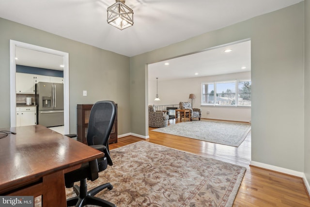 office featuring recessed lighting, light wood-style flooring, and baseboards