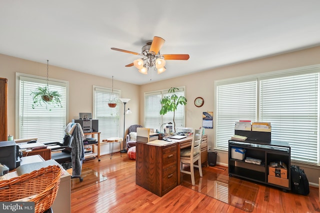 office area featuring baseboards, a ceiling fan, and wood finished floors