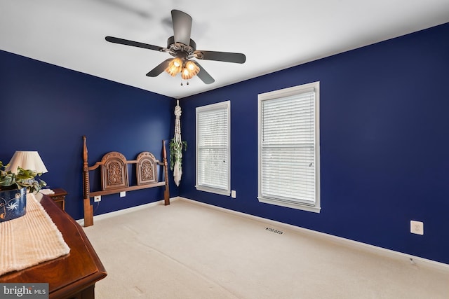 bedroom with carpet, visible vents, ceiling fan, and baseboards