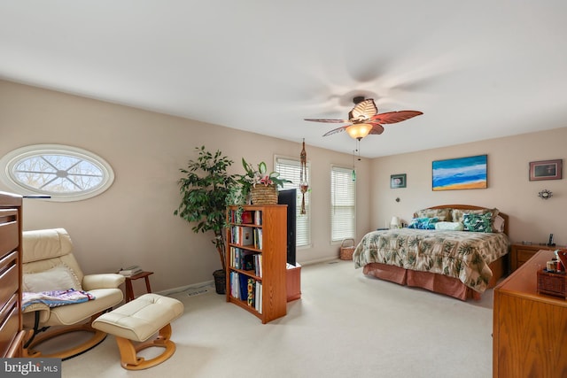 carpeted bedroom with visible vents and ceiling fan