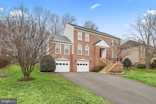 view of front facade with aphalt driveway, a front yard, brick siding, and a garage