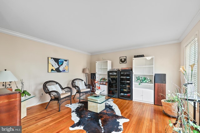 living room featuring light wood finished floors and ornamental molding