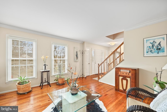 living room with baseboards, stairway, hardwood / wood-style floors, and ornamental molding