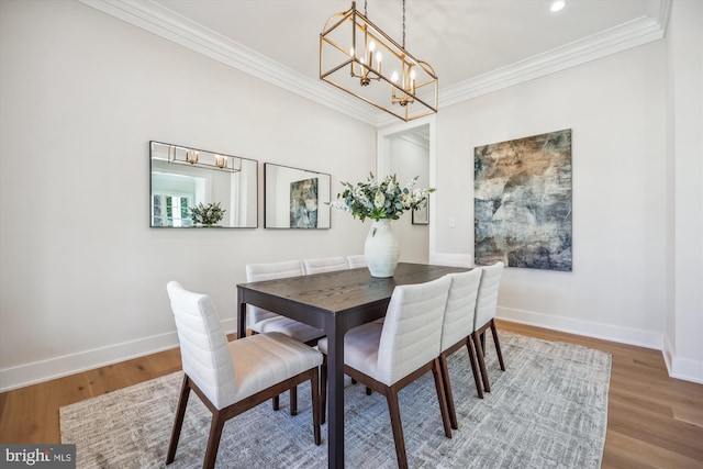 dining space featuring recessed lighting, wood finished floors, baseboards, and ornamental molding