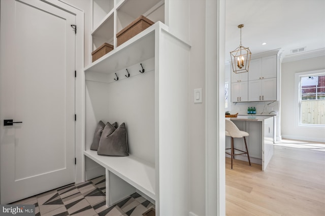 mudroom with recessed lighting, visible vents, light floors, and a chandelier