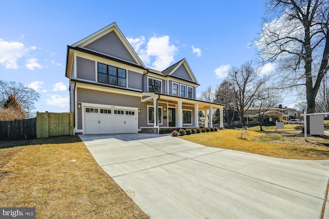 view of front of house featuring driveway, fence, covered porch, a front yard, and a garage