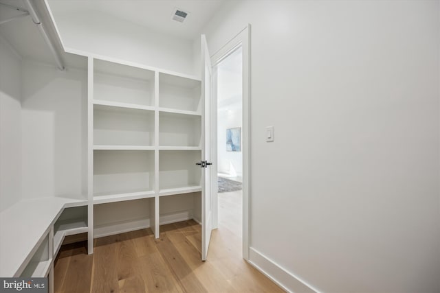 spacious closet with light wood finished floors and visible vents