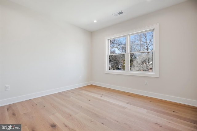 empty room featuring recessed lighting, visible vents, baseboards, and light wood finished floors