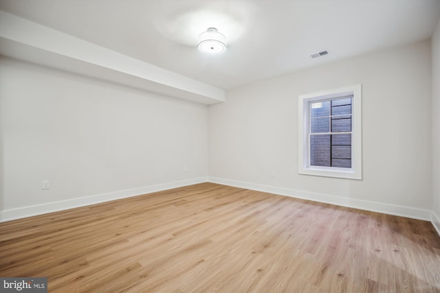 spare room with visible vents, baseboards, and light wood-style floors