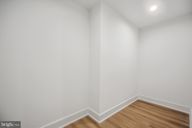 unfurnished room with baseboards and light wood finished floors