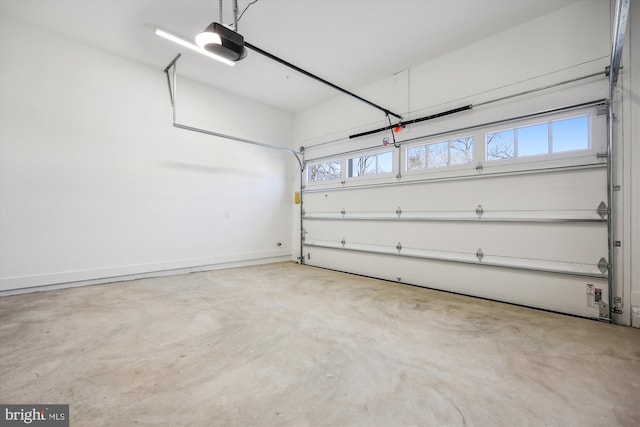 garage with a garage door opener and baseboards