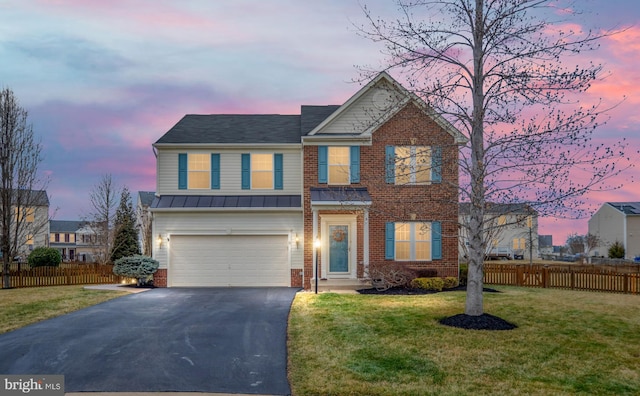 view of front of property featuring an attached garage, brick siding, fence, driveway, and a front lawn