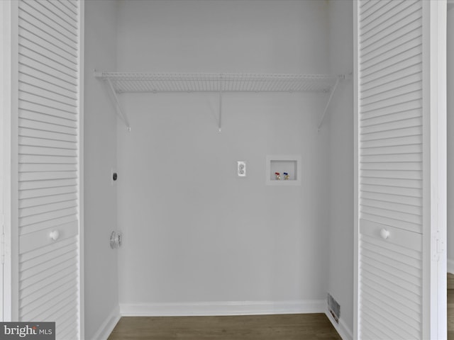 laundry area with dark wood-style floors, washer hookup, electric dryer hookup, laundry area, and baseboards