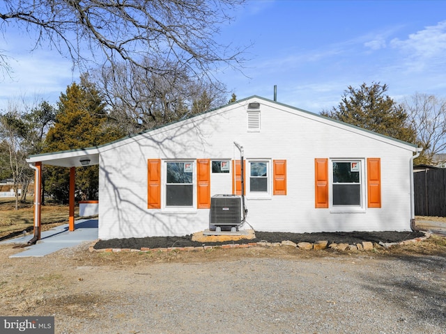 view of front of house with cooling unit and brick siding