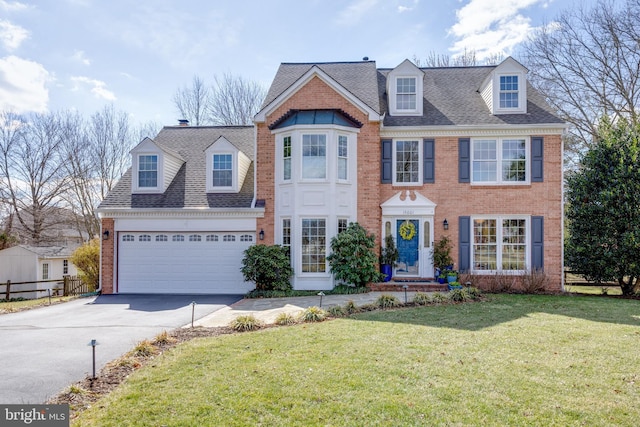 view of front of property with a garage, brick siding, fence, concrete driveway, and a front lawn