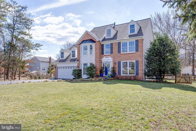 view of front of property featuring a garage, brick siding, a shingled roof, fence, and a front yard