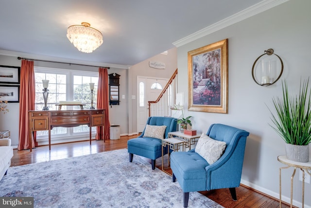 sitting room with crown molding, baseboards, and wood finished floors