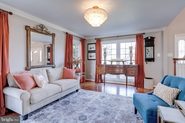 living area featuring a healthy amount of sunlight, crown molding, and wood finished floors