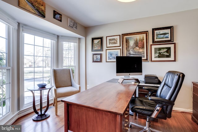 home office with wood finished floors and baseboards