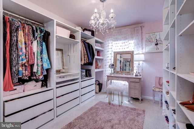 walk in closet featuring a chandelier and carpet