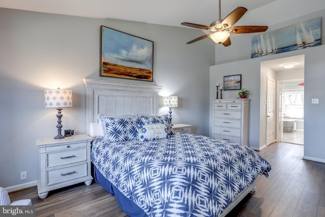 bedroom featuring a ceiling fan, connected bathroom, baseboards, and wood finished floors