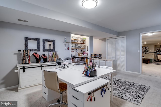 office area with light carpet, baseboards, and visible vents