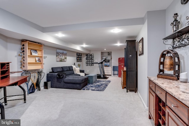 living room with baseboards and light colored carpet