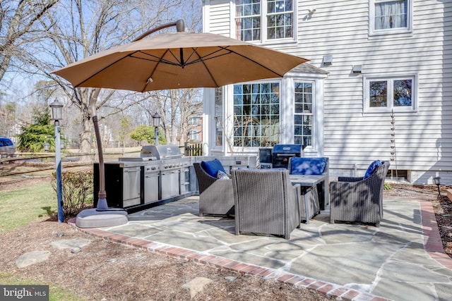 view of patio / terrace with a grill and fence