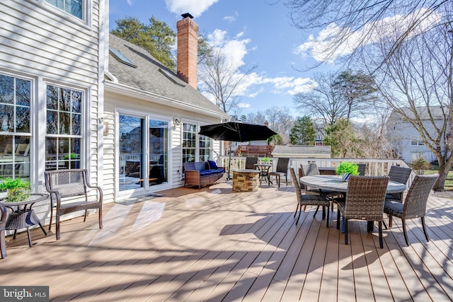 wooden terrace with outdoor dining space