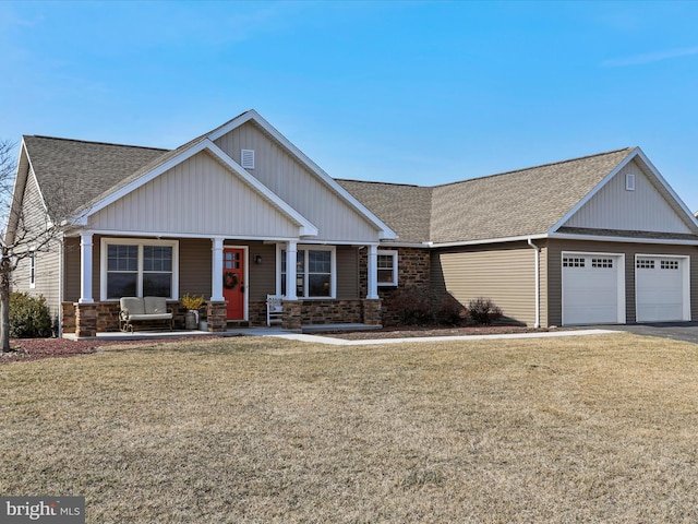 craftsman inspired home with a garage, a shingled roof, a porch, and a front lawn