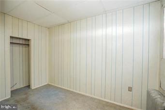 carpeted spare room with radiator