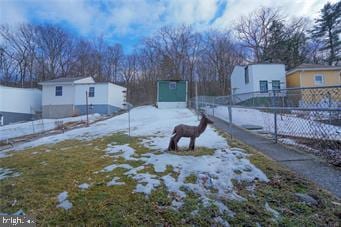 snowy yard with fence