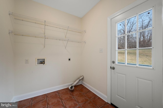 laundry room featuring laundry area, baseboards, dark tile patterned flooring, hookup for a washing machine, and electric dryer hookup