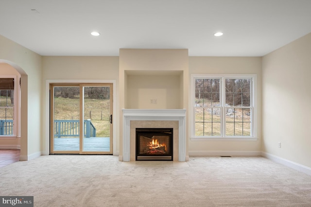 unfurnished living room with recessed lighting, carpet flooring, and a healthy amount of sunlight