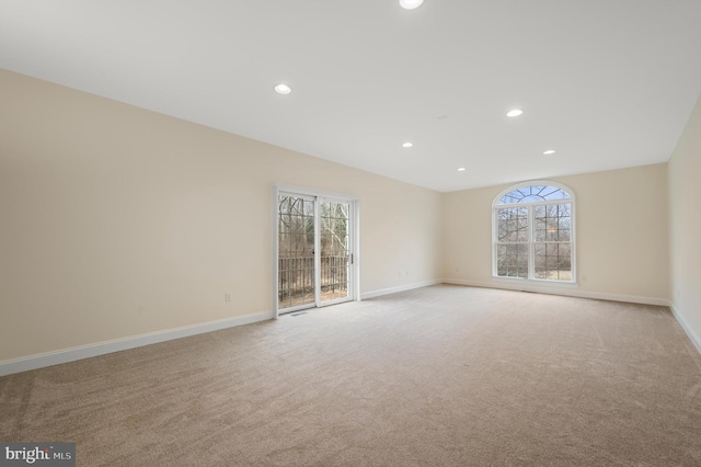 unfurnished room with baseboards, recessed lighting, and light colored carpet