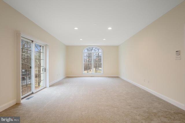 spare room featuring recessed lighting, visible vents, baseboards, and light colored carpet