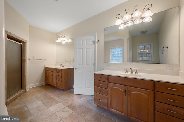 bathroom with a stall shower, two vanities, and a sink