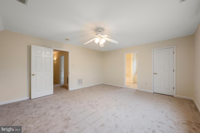 unfurnished bedroom with visible vents, carpet flooring, ceiling fan, ensuite bath, and baseboards