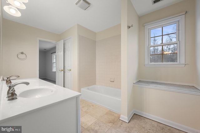 bathroom with  shower combination, visible vents, a sink, and baseboards