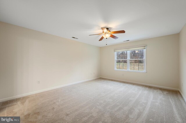 unfurnished room with baseboards, visible vents, a ceiling fan, and light colored carpet