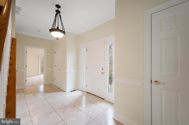 entrance foyer with light tile patterned floors, ornamental molding, and baseboards