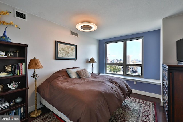 bedroom with baseboards and visible vents