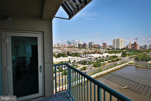 balcony featuring a view of city and a water view